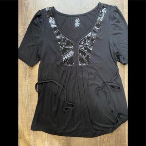 Black maternity top with sequin.